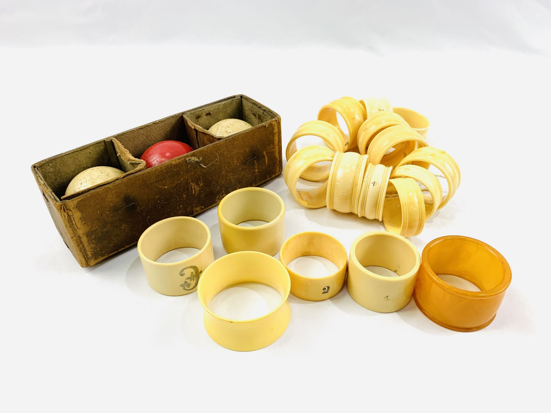 A group of napkin rings and a set of ivory billiard balls.