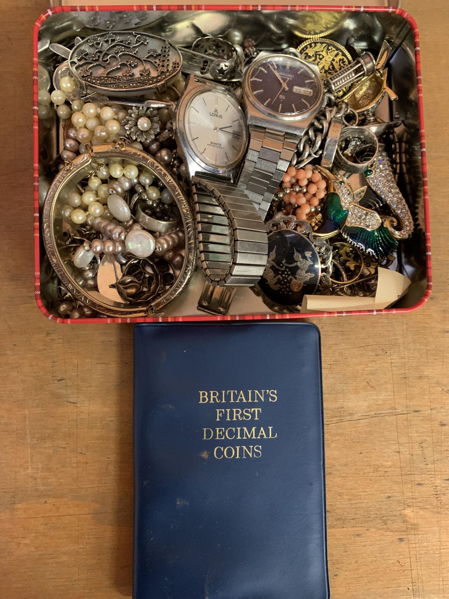 Two quartz wristwatches and a tin of costume jewellery