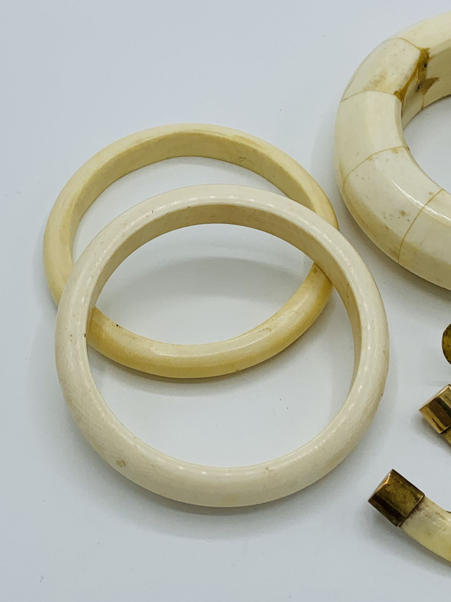 Three bone bangles and 3 yellow metal mounted animals' teeth brooches - Image 3 of 5