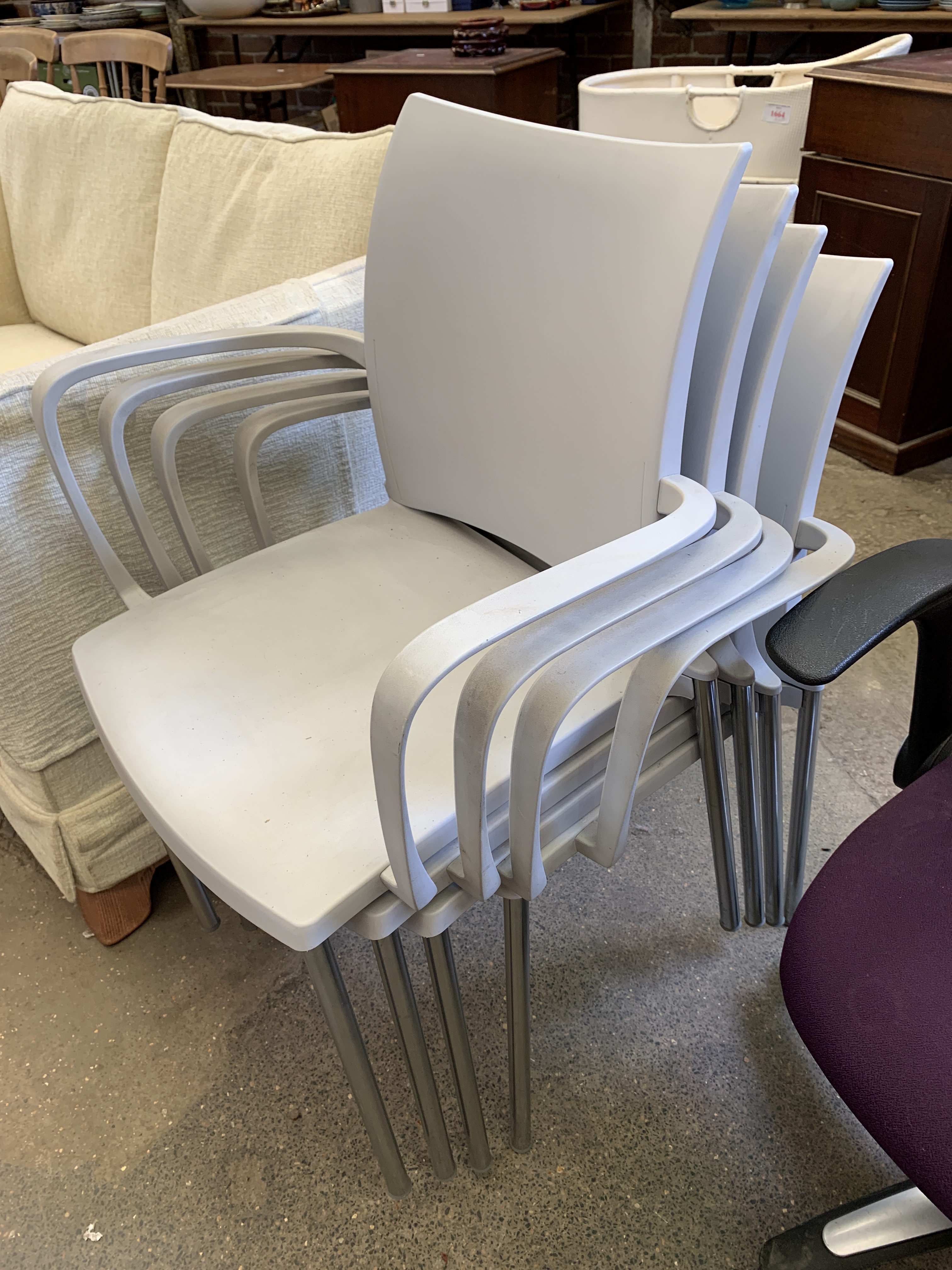 Four Cuscho light grey plastic and chrome stackable armchairs - Image 2 of 3