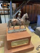 Sixteen metal horse and rider trophies on mahogany bases with brass inscription plaques