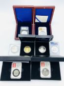 A collection of commemorative coins, in capsules and mostly boxed