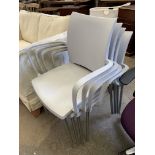 Four Cuscho light grey plastic and chrome stackable armchairs