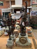 Green marble and spelter figural clock with a pair of four branch candelabra garnitures