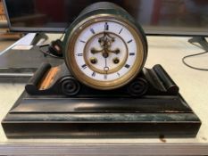 Black painted mantel clock with visible escapement