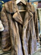 Brown fur cape, dark brown fur coat, and black Astrakhan coat