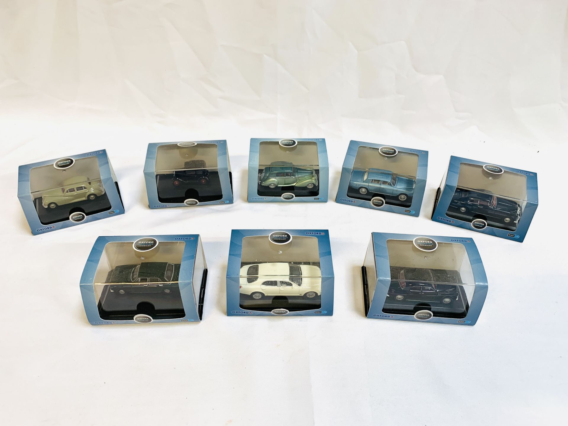 Eight Oxford diecast scale 1:76 model cars, and a Mercedes Benz Mbig 2002