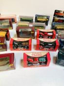 Nineteen boxed various diecast model buses, lorries and cars.