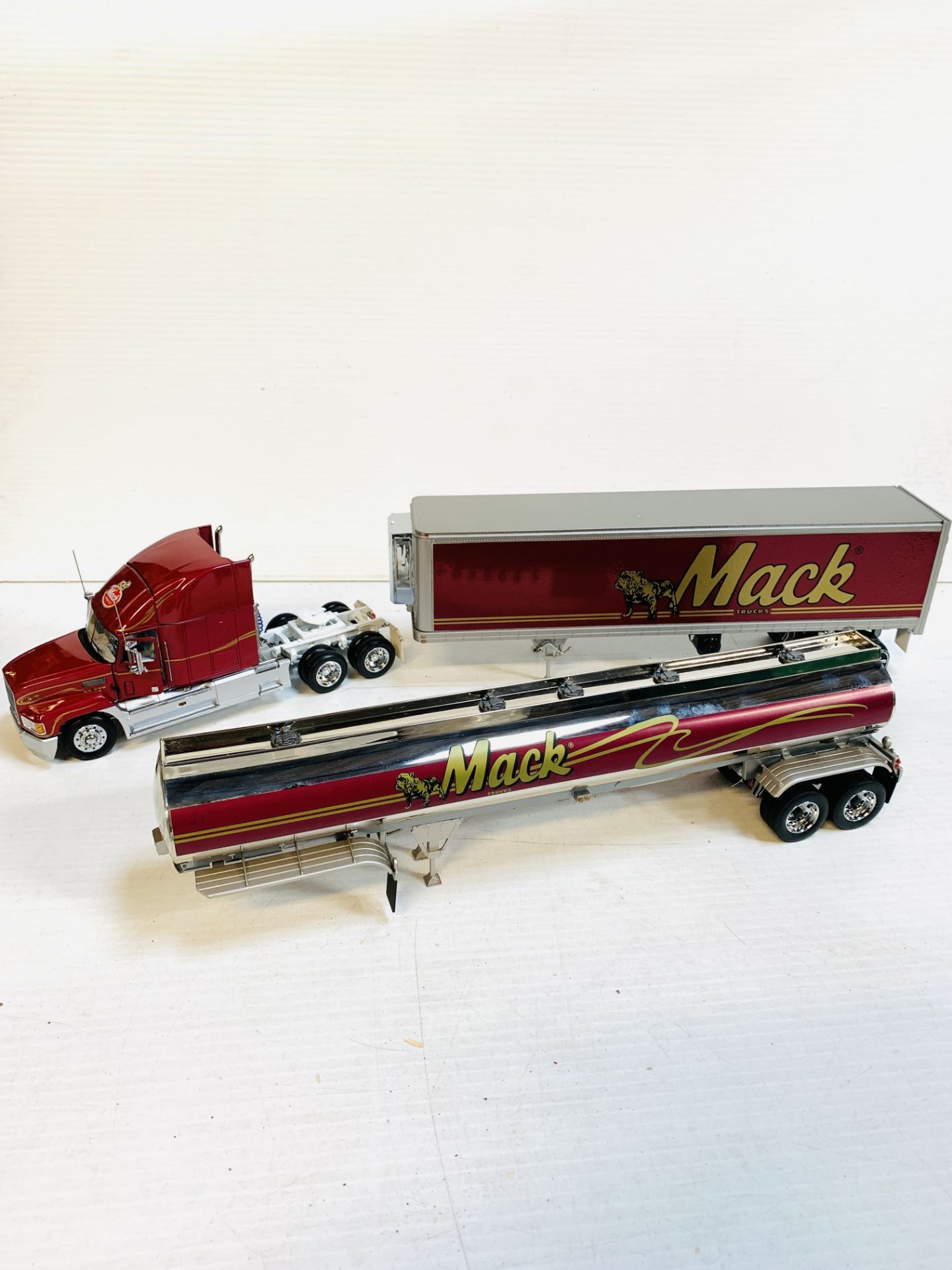 Franklin Mint 1:32 scale 1993 Mack truck; together with a Mack tanker and refrigerated trailer.