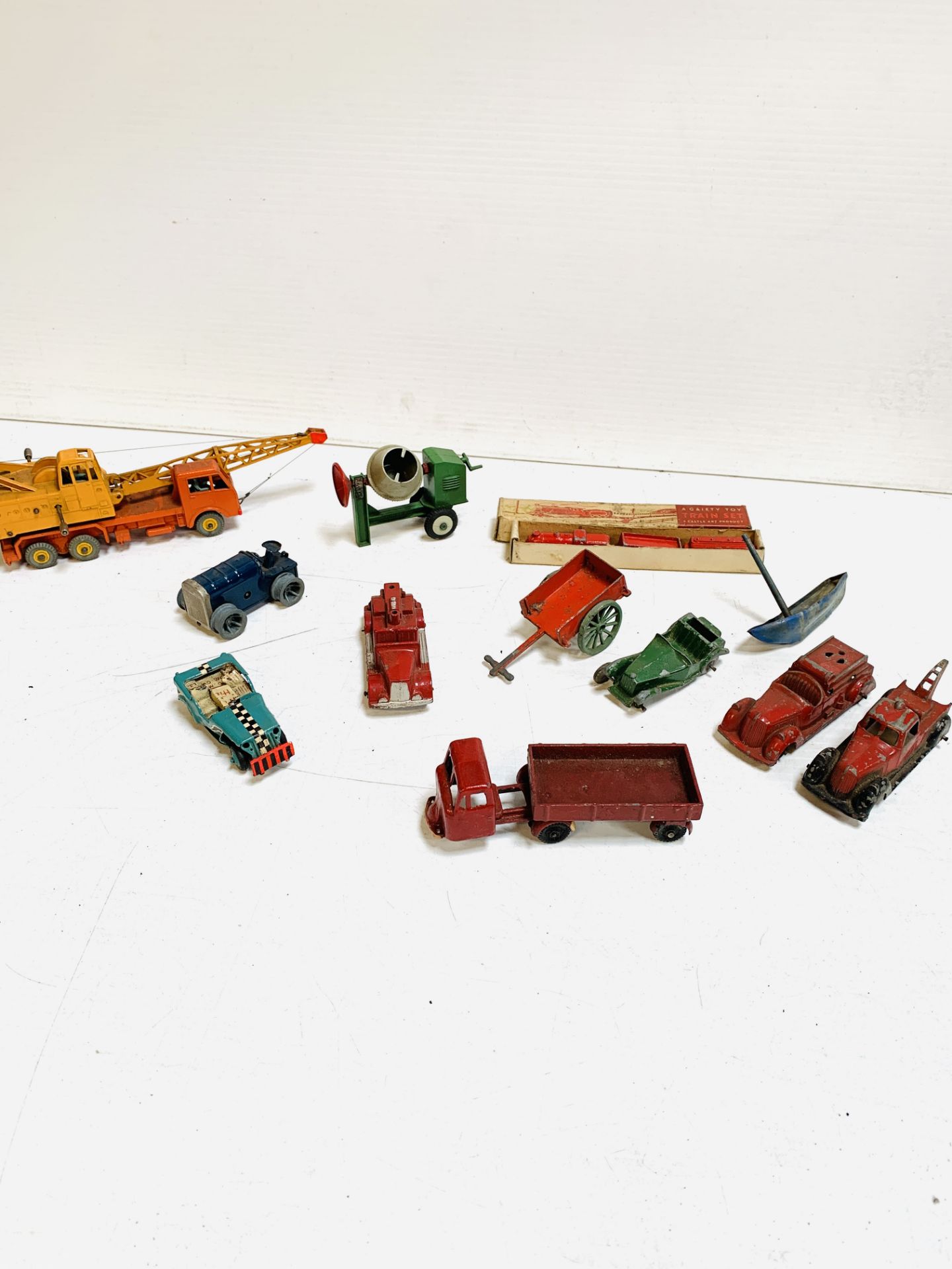 Dinky 20 ton lorry mounted crane; Gaiety toy train set; Tri-ang Minic clockwork model racing car