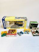 A collection of die-cast models including a Joal Komatsu material handler and Dinky