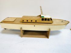 Wooden model cabin cruiser on stand, no engine.