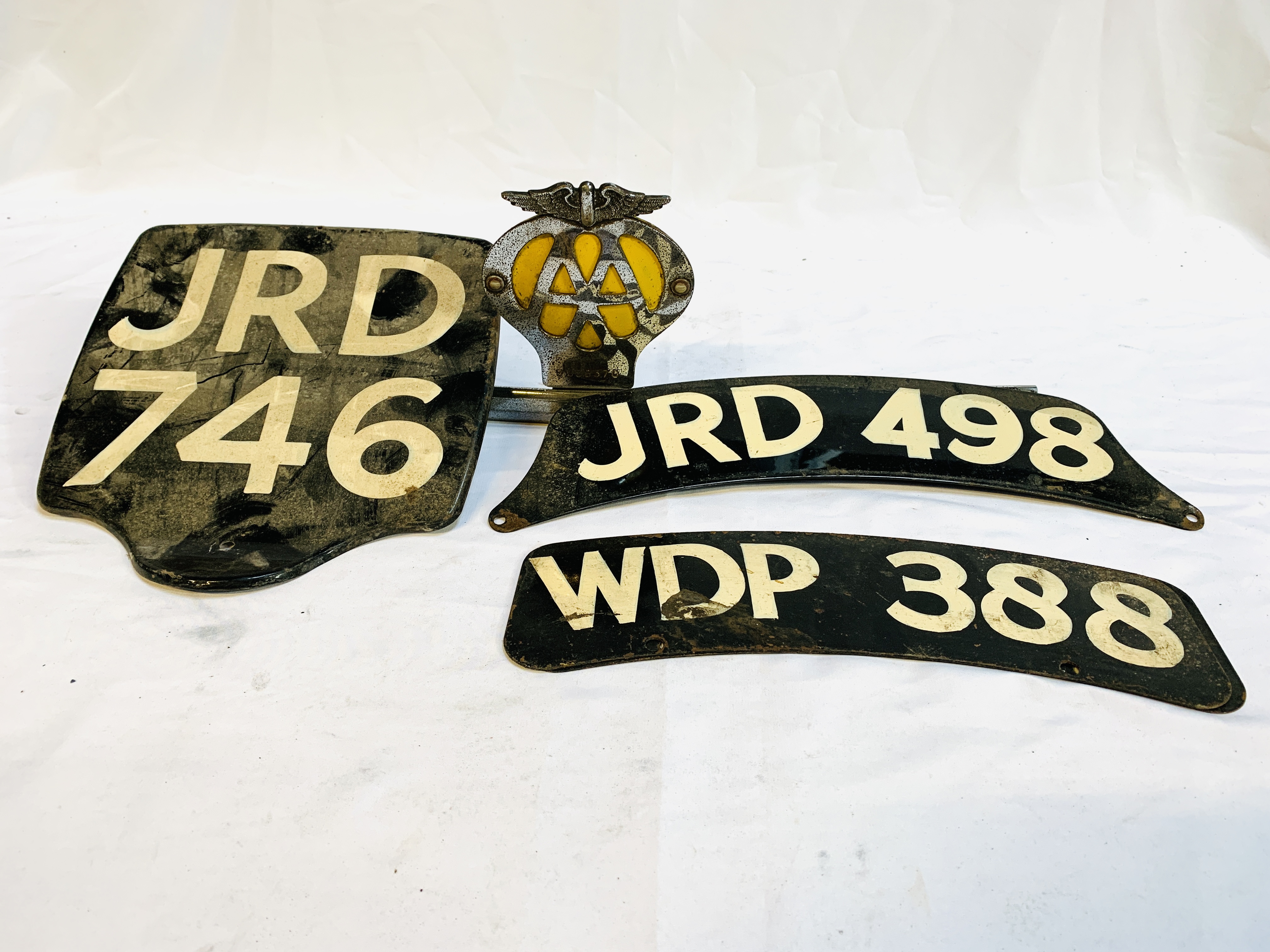 AA badge no. 6B58370; motorcycle rear number plate; and two motorcycle front number plates.