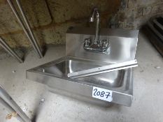 Stainless steel hand sink with tap.