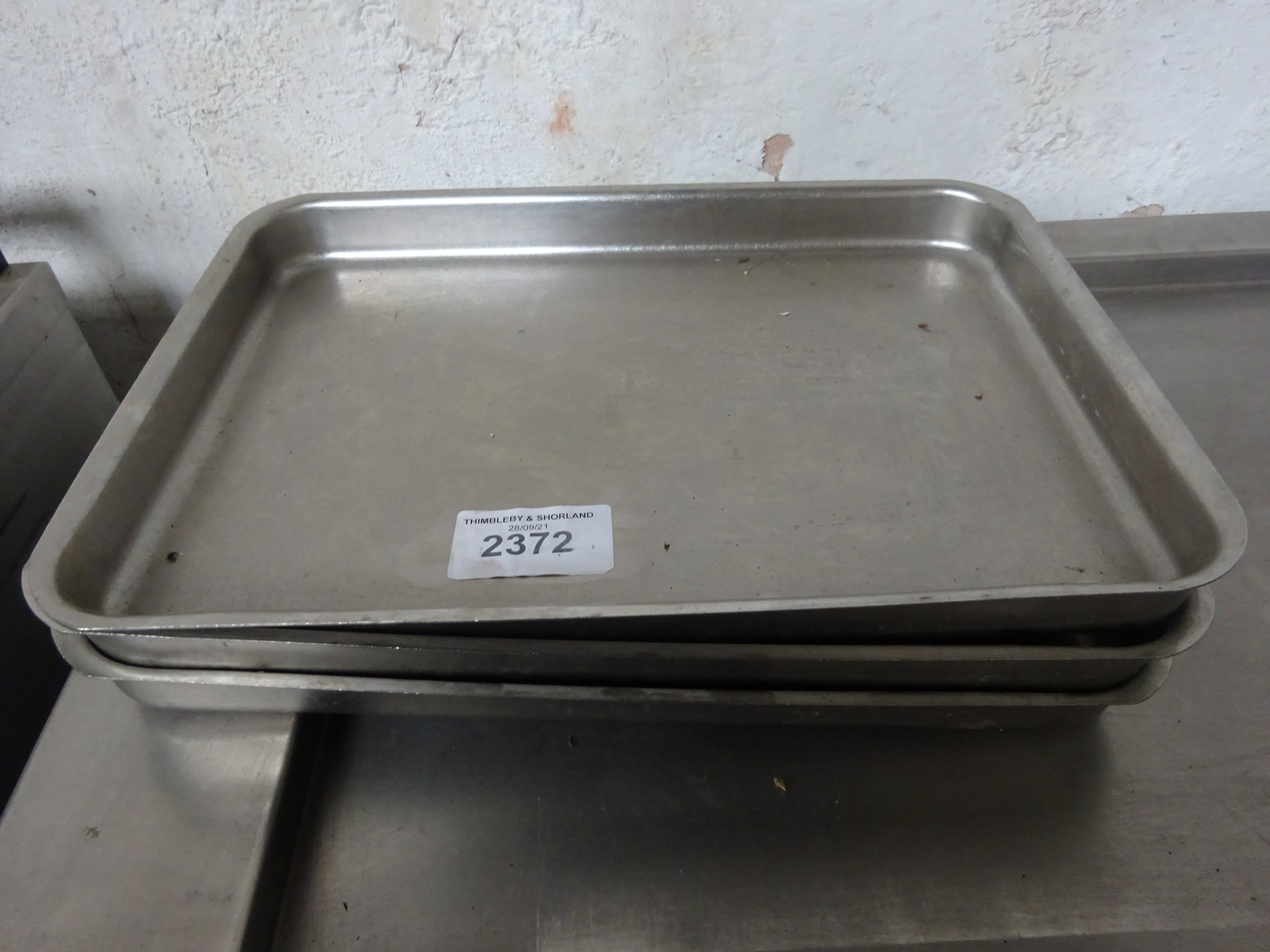 Three stainless steel baking trays