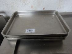 Three stainless steel baking trays