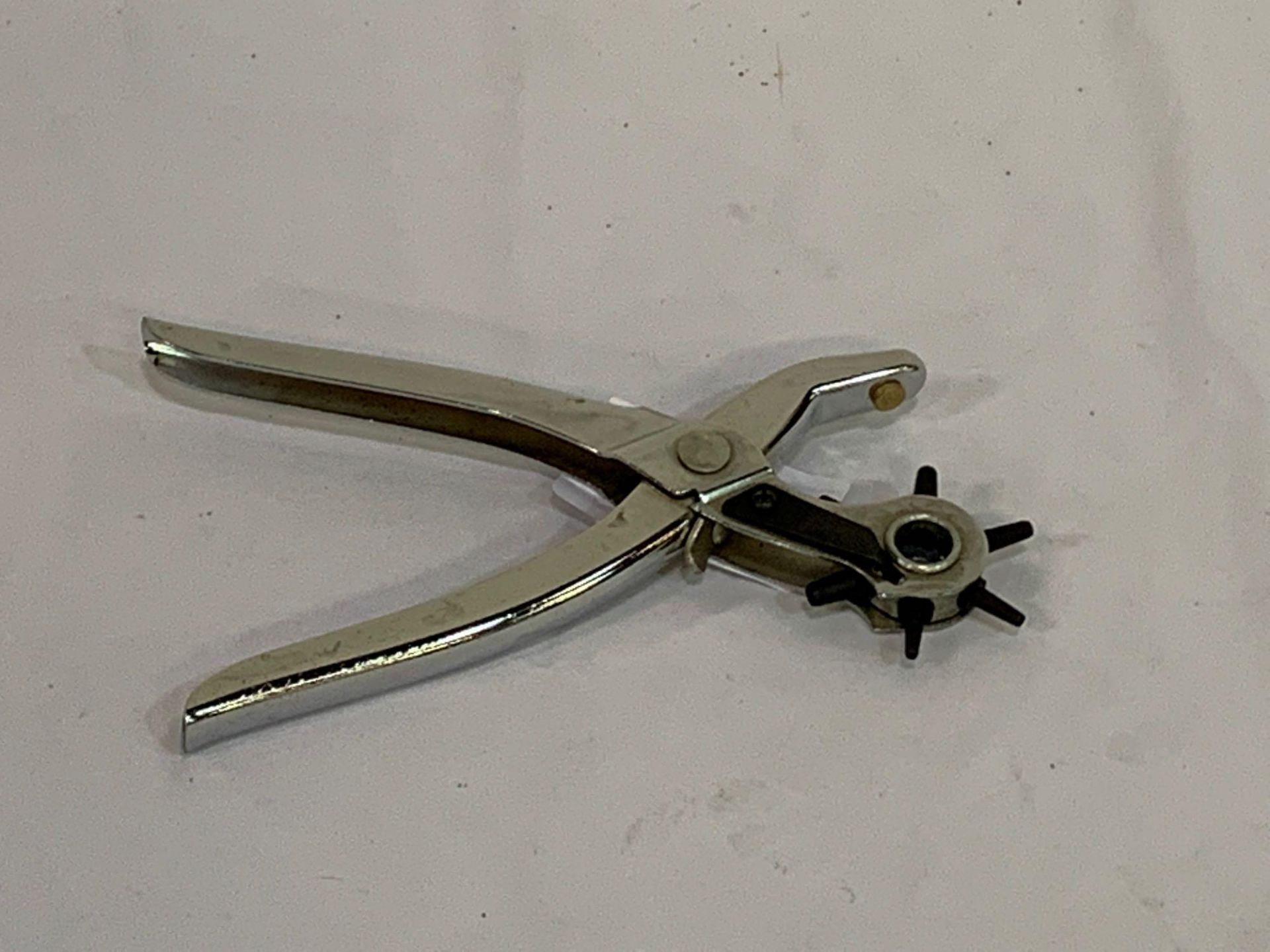 Chrome leather hole punch (adjustable).