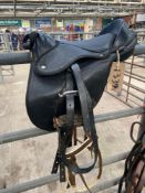 Child's synthetic saddle together with a webbing bridle.
