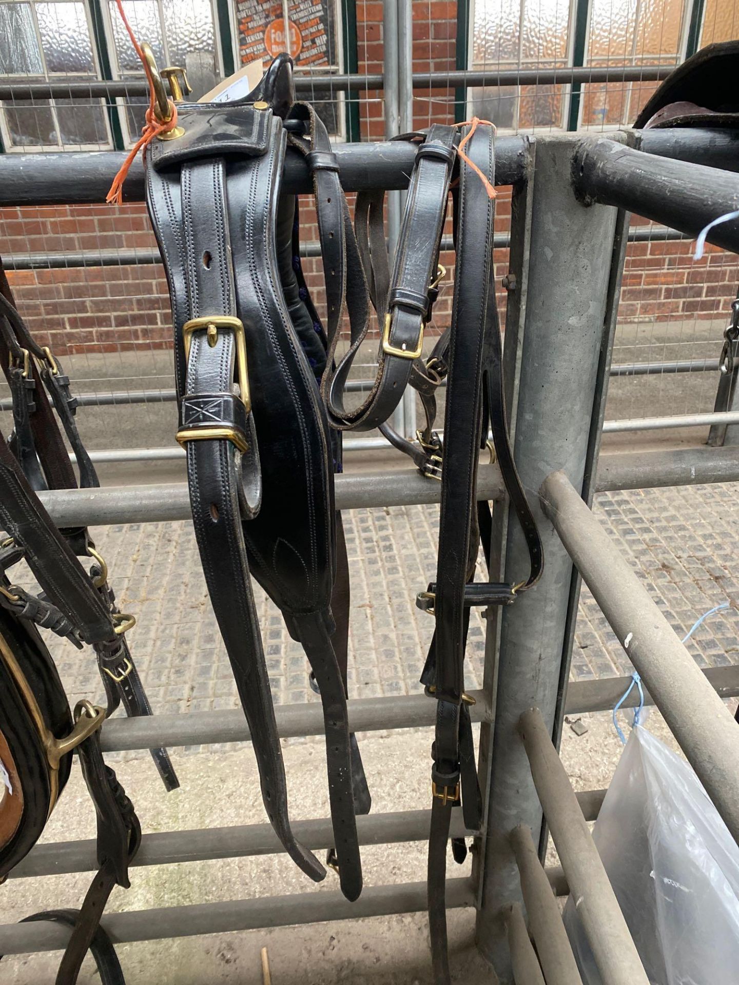 Part set of black/brown leather pony harness.