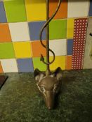 Brass door stop in the form of a fox's head and a hunt whip.