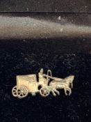Whitemetal brooch of a horse and carriage