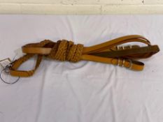 Pair of leather plaited reins with horseshoe buckles. This item carries VAT.