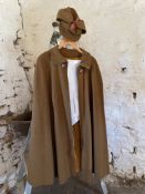 Brown cape with matching hat and a pair of men's white breeches