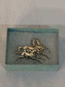 White metal brooch of a galloping mare and foal