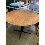 Circular teak table on metal pedestal base