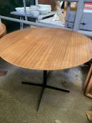 Circular teak table on metal pedestal base