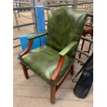 Green leather effect open armchair