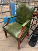 Green leather effect open armchair