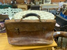 A leather satchel together with two ladies summer hats