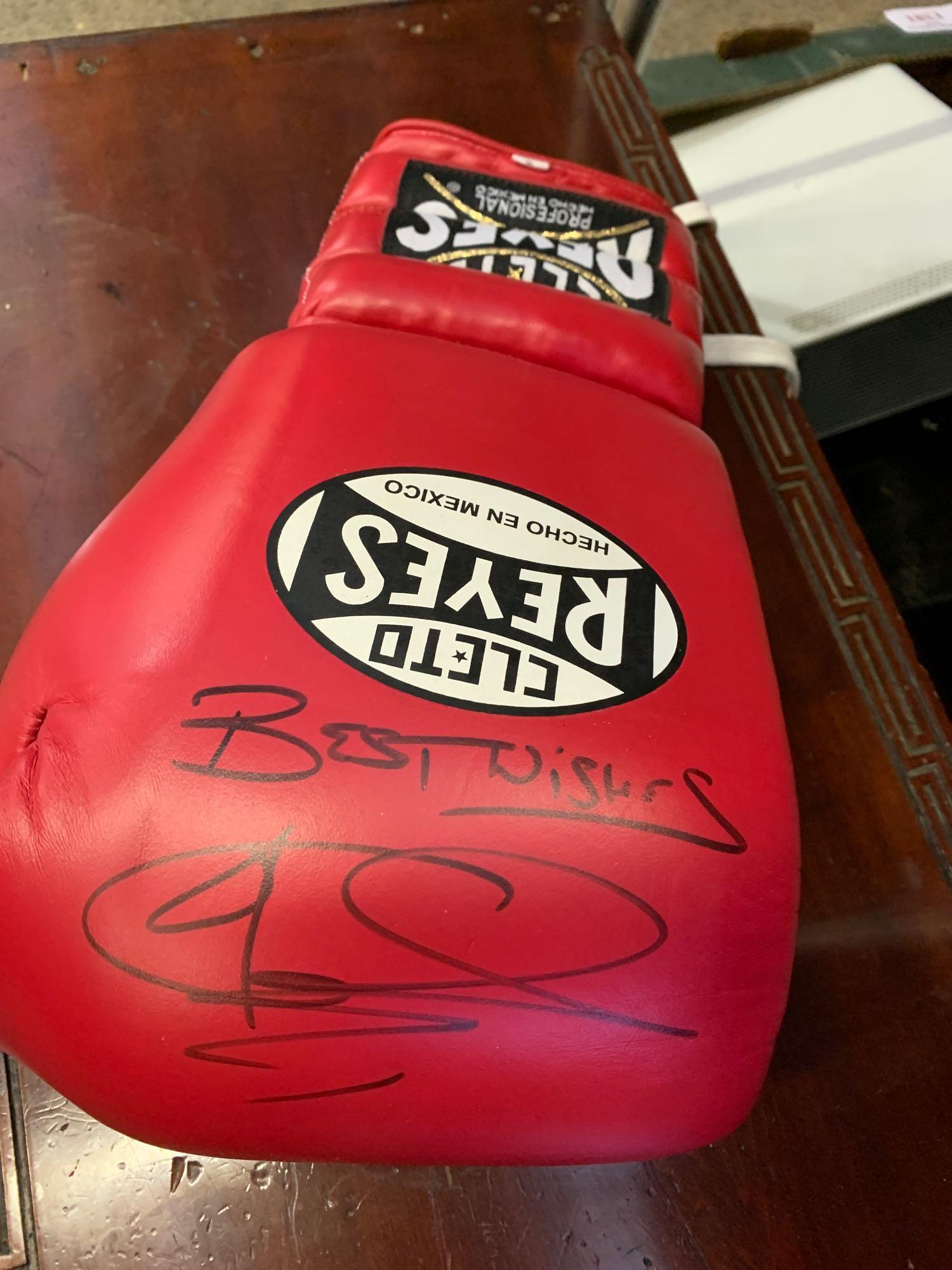 Signed boxing glove. This item carries VAT.