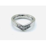 18ct white gold ring in wishbone design, channel set with five brilliant cut diamonds