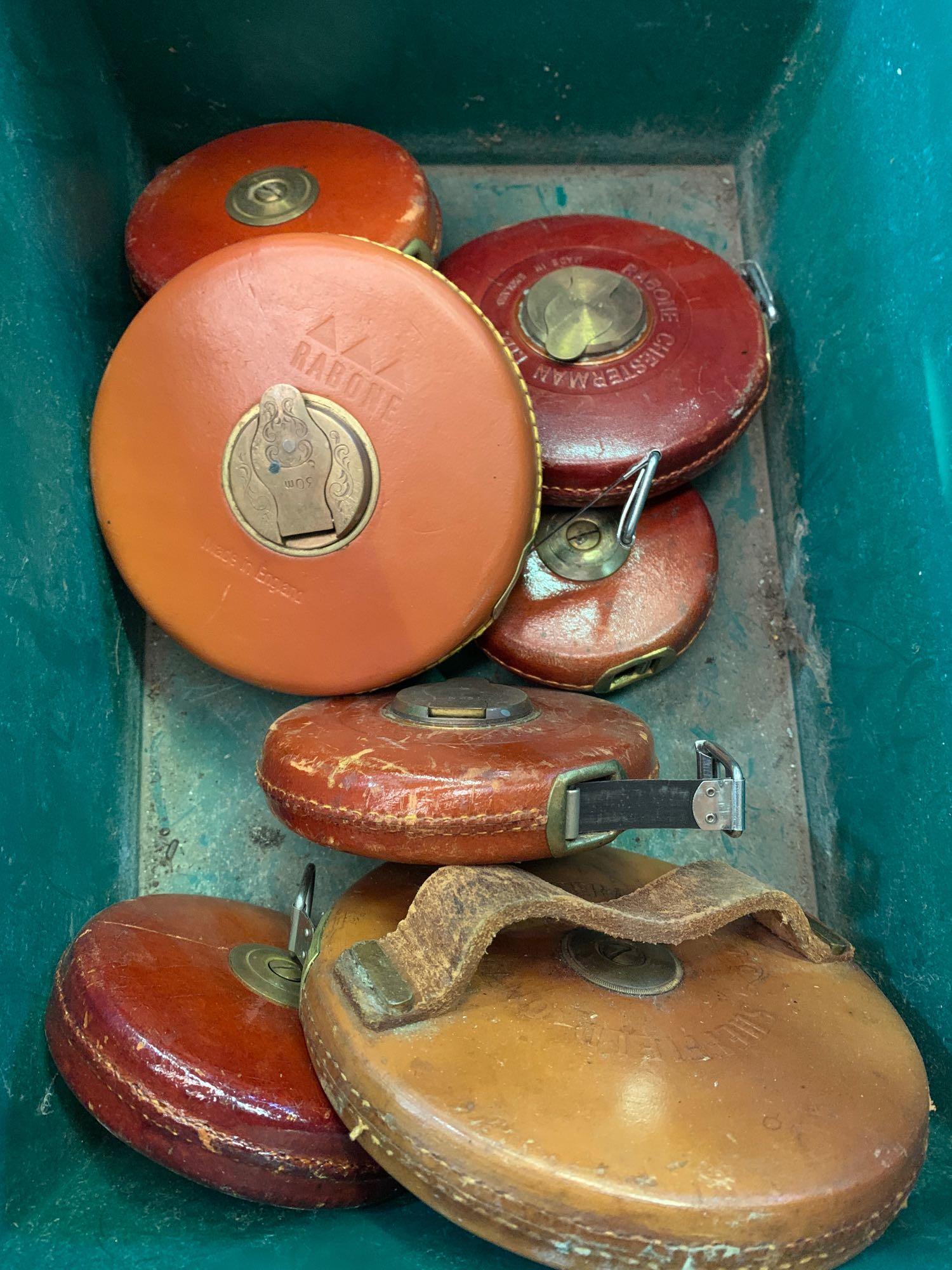 Eight leather cased tape measures