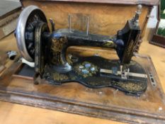 Manual sewing machine in walnut box decorated with parquetry