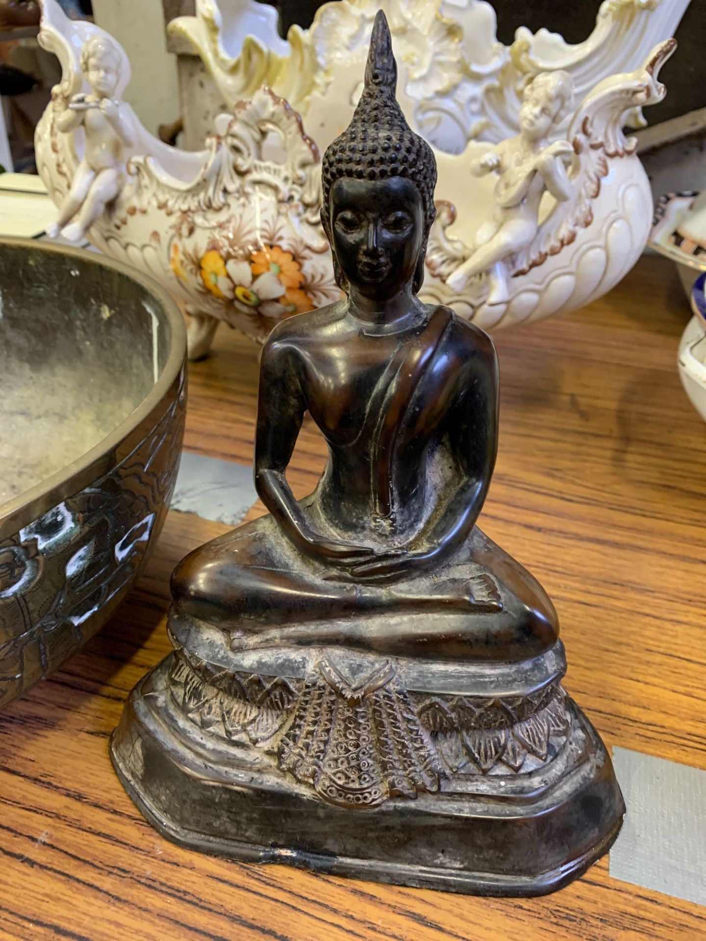 Oriental brass bowl together with a resin figurine