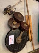 Six leather cased tape measures and four boxwood rules