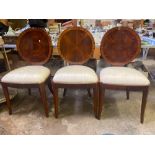 Three round back dining chairs and a foot stool
