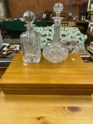 Two cut glass decanters and a canteen of silverplate cutlery