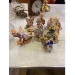 Two Capodimonte figures together with five ceramic faeries