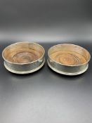 A pair of hallmarked silver and mahogany bottle coasters