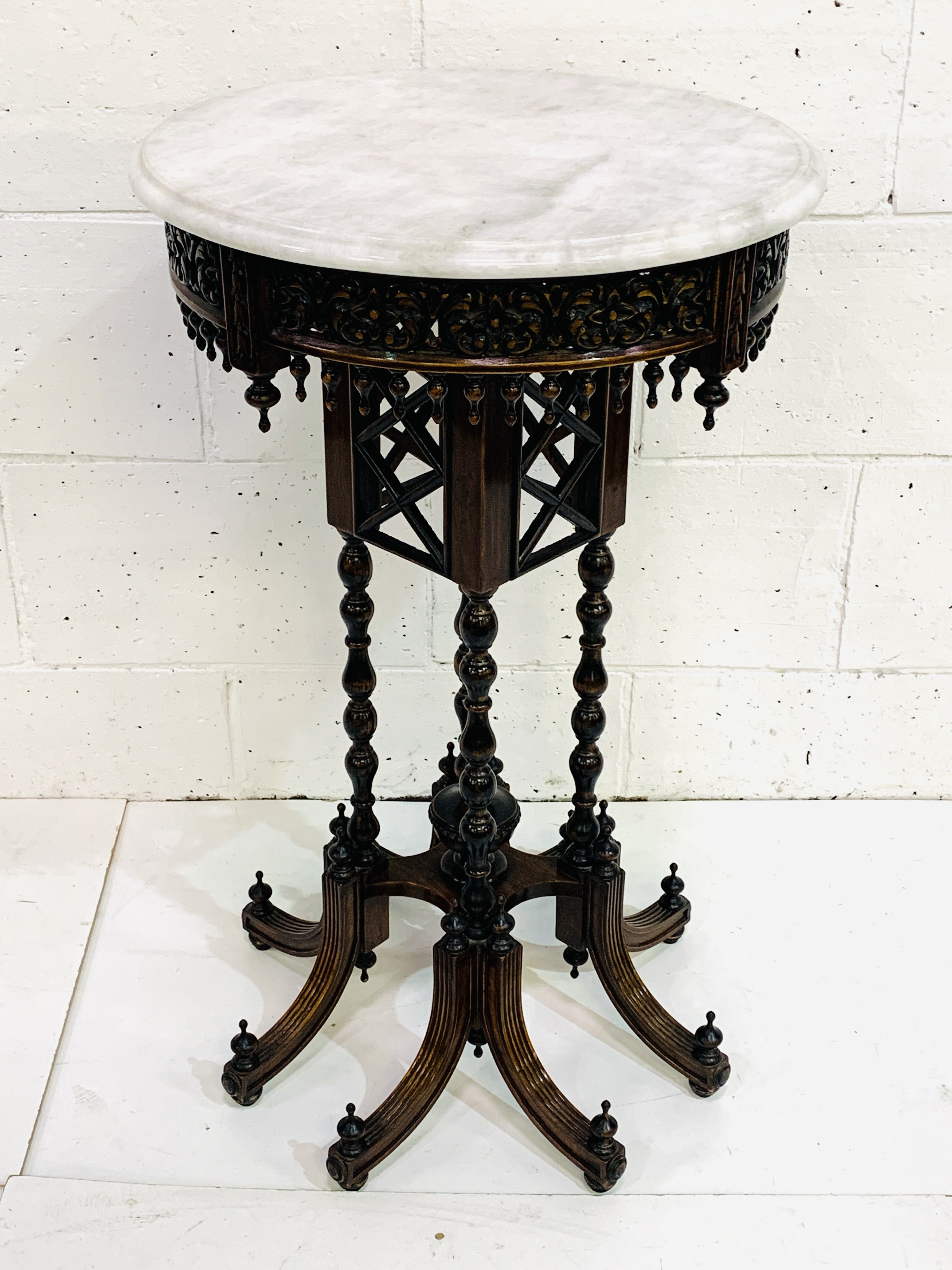 Ornately carved marble topped display table