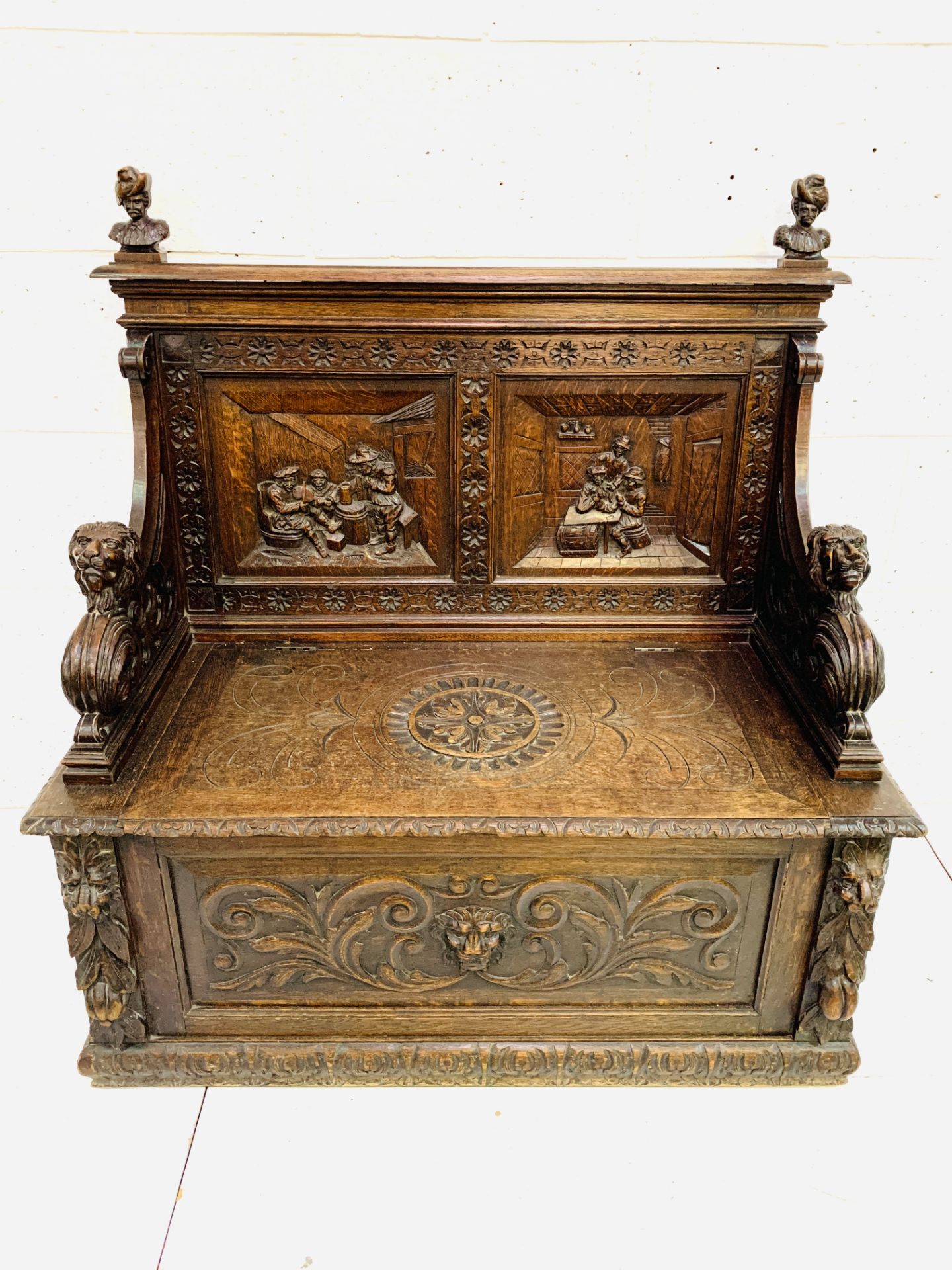 Heavily carved oak settle