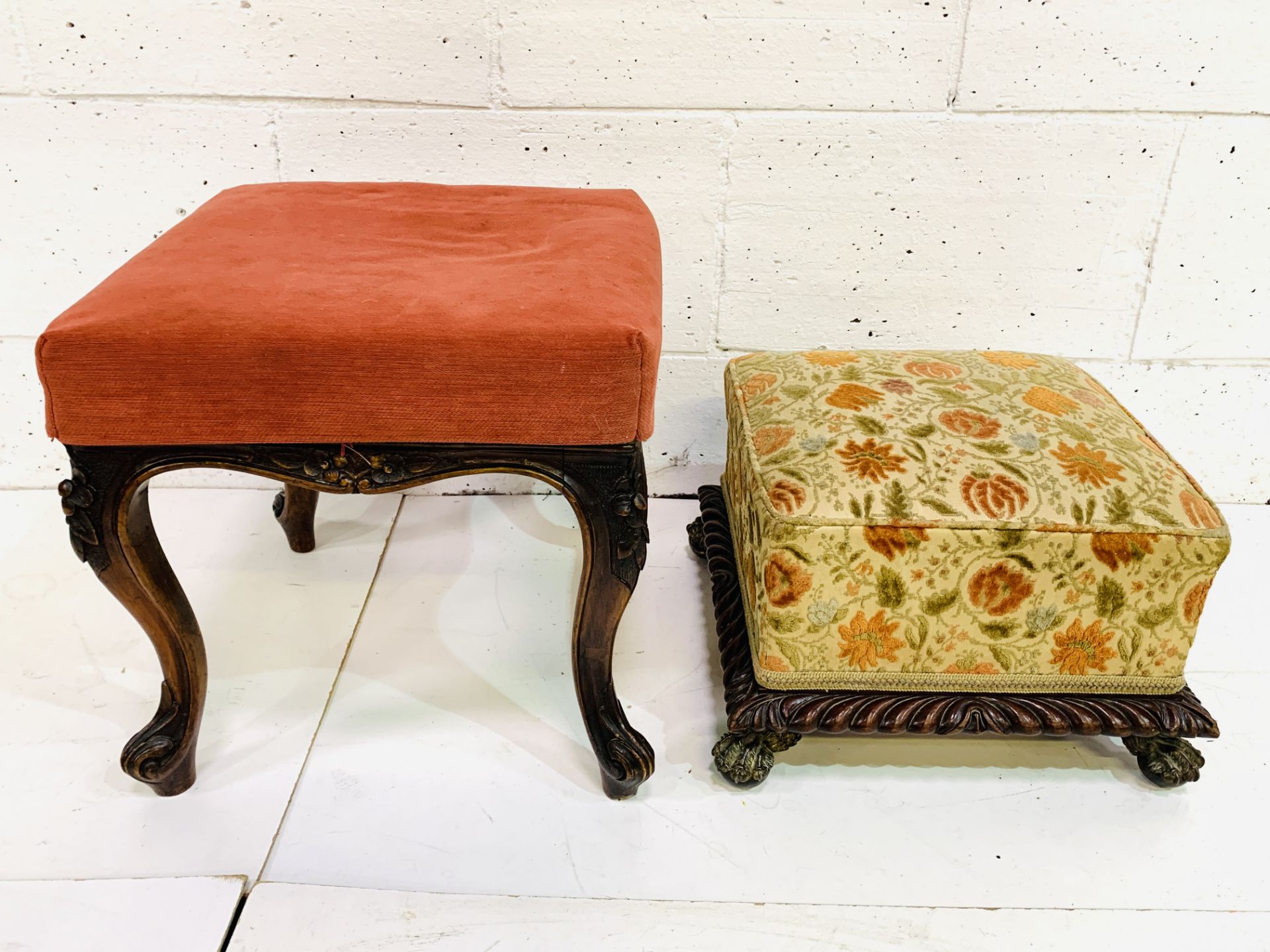 Carved mahogany footstool together with an upholstered footstool