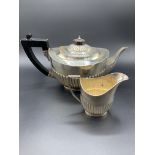 A silver teapot and a silver jug by William Hutton and Sons Ltd