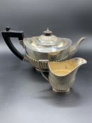 A silver teapot and a silver jug by William Hutton and Sons Ltd