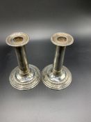 A pair of silver columned candlesticks hallmarked Sheffield 1904