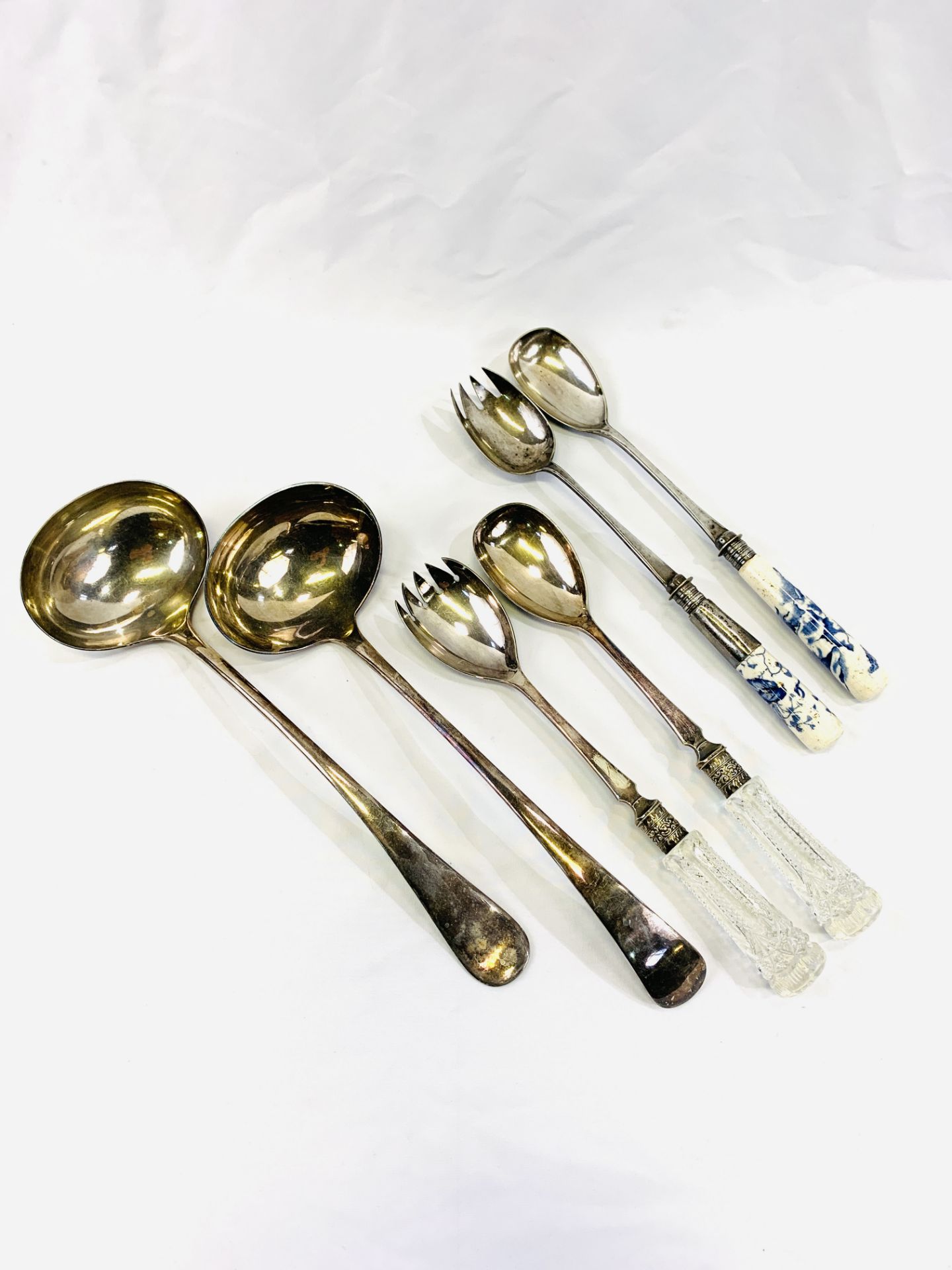 Two silver plate ladles and two pairs of salad servers